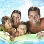 Family On Holiday In Swimming Pool