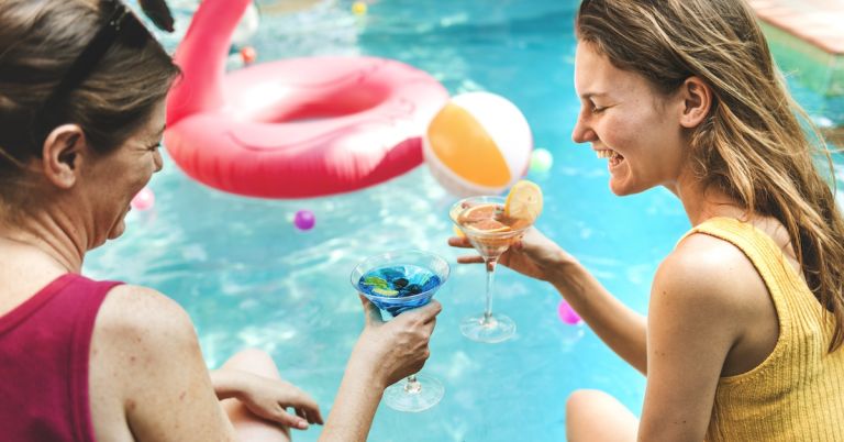 Relaxing pool party with clean, crystal-clear water using Clear Comfort AOP water treatment system and low-chlorine pool water care